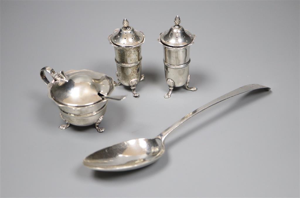 An Edwardian silver three piece condiment set with spoon, Birmingham, 1903 and a George III silver table spoon, London, 1784,
